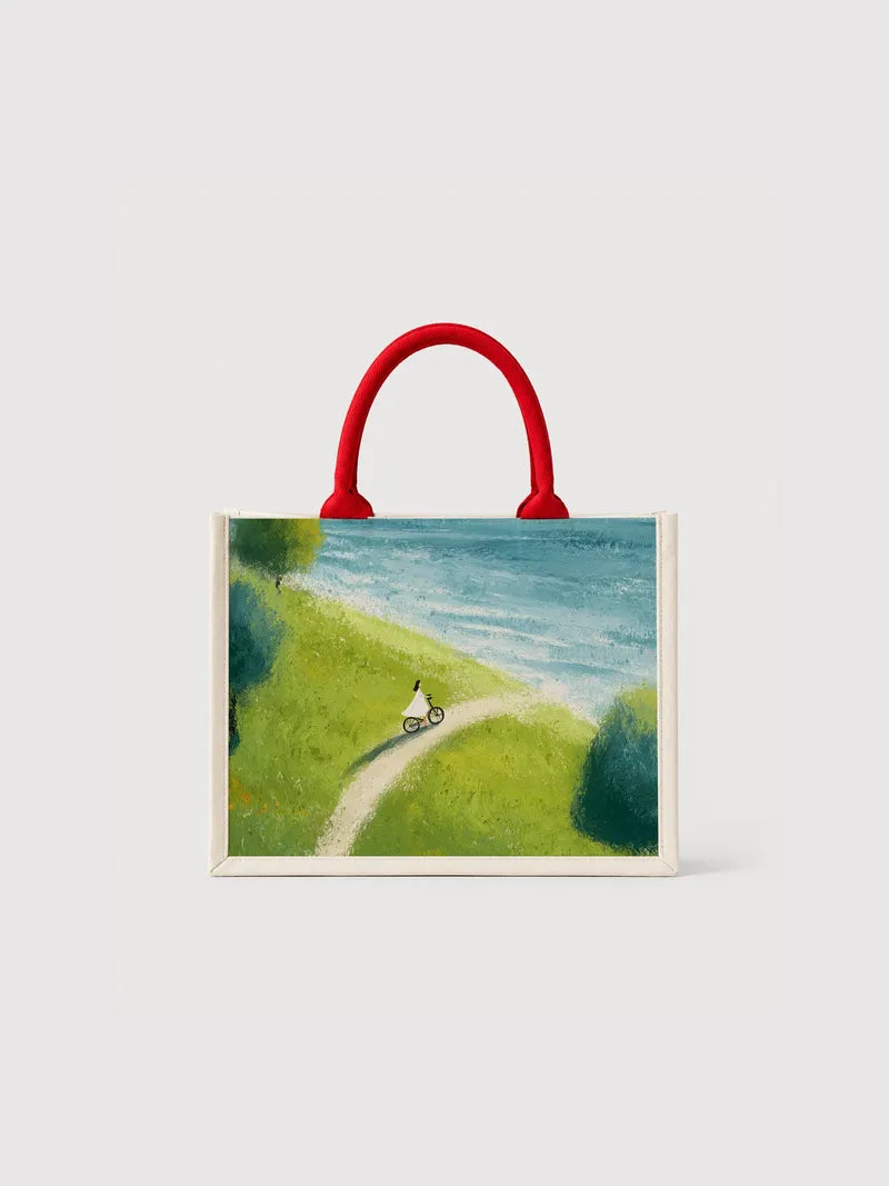 Cyclist by the Sea Canvas Bag